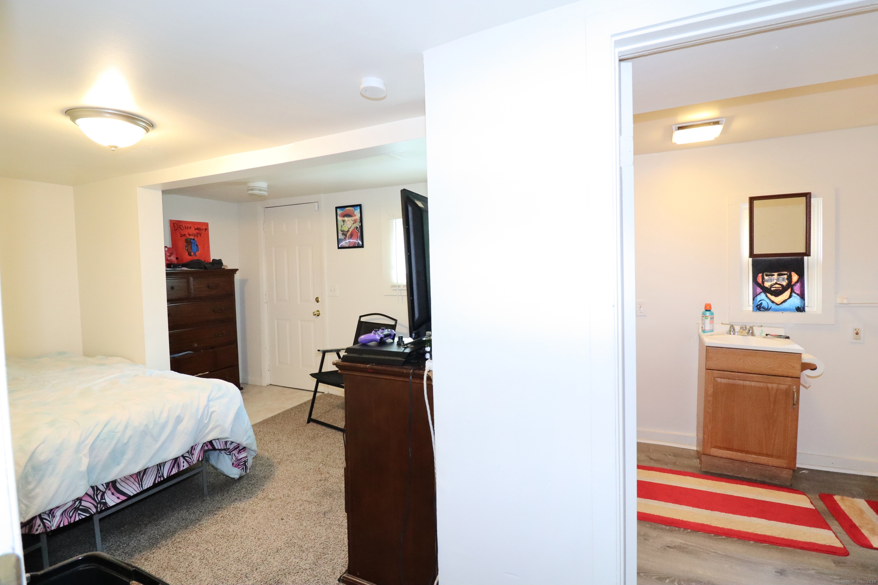 60 Olive Street Bridgeport, CT 06605 - Photo 16 of 34 a bedroom with a bed and a cabinets