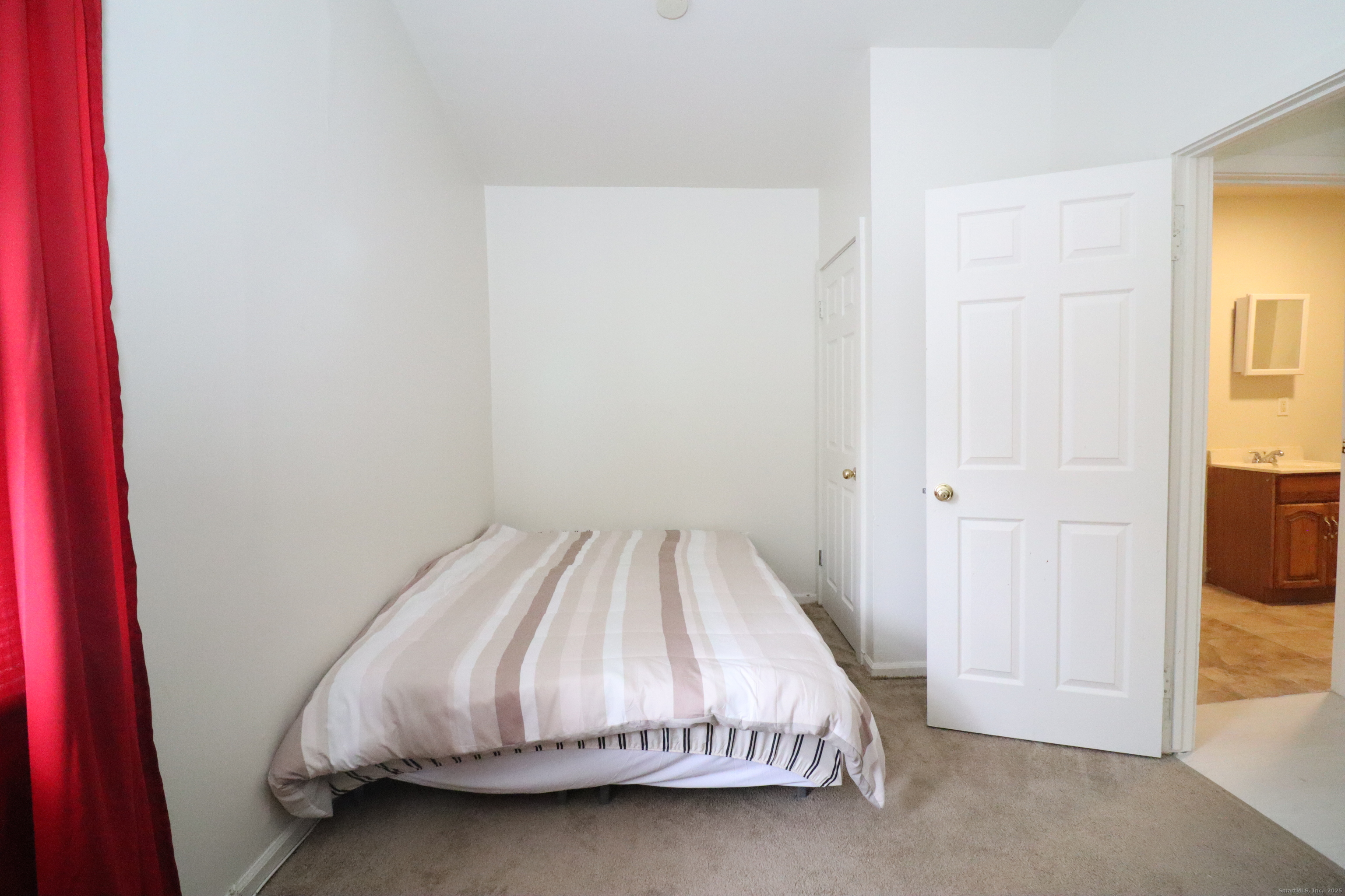 60 Olive Street Bridgeport, CT 06605 - Photo 23 of 34 a bed sitting in a bedroom next to a window