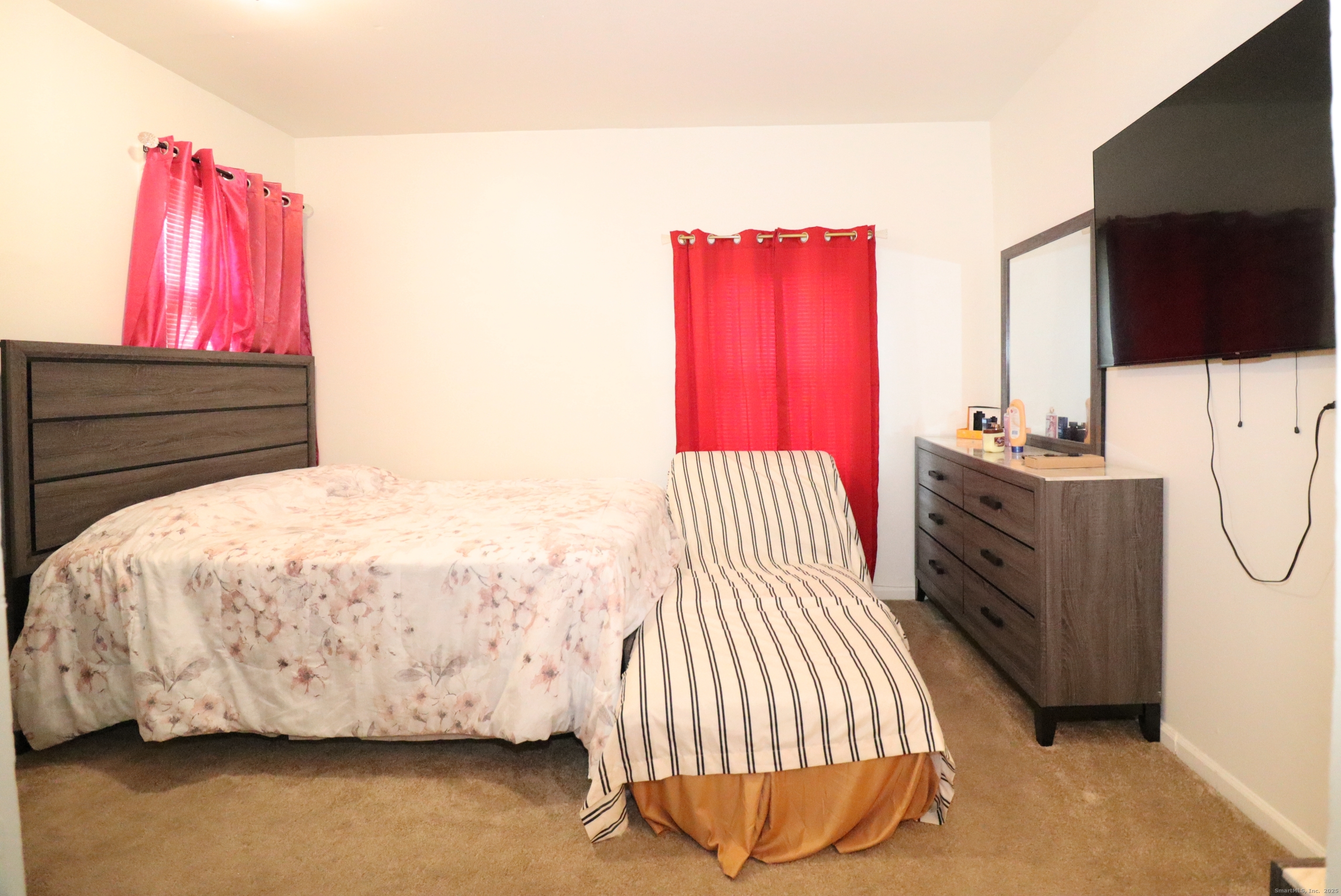 60 Olive Street Bridgeport, CT 06605 - Photo 28 of 34 a bedroom with a bed and a flat screen tv