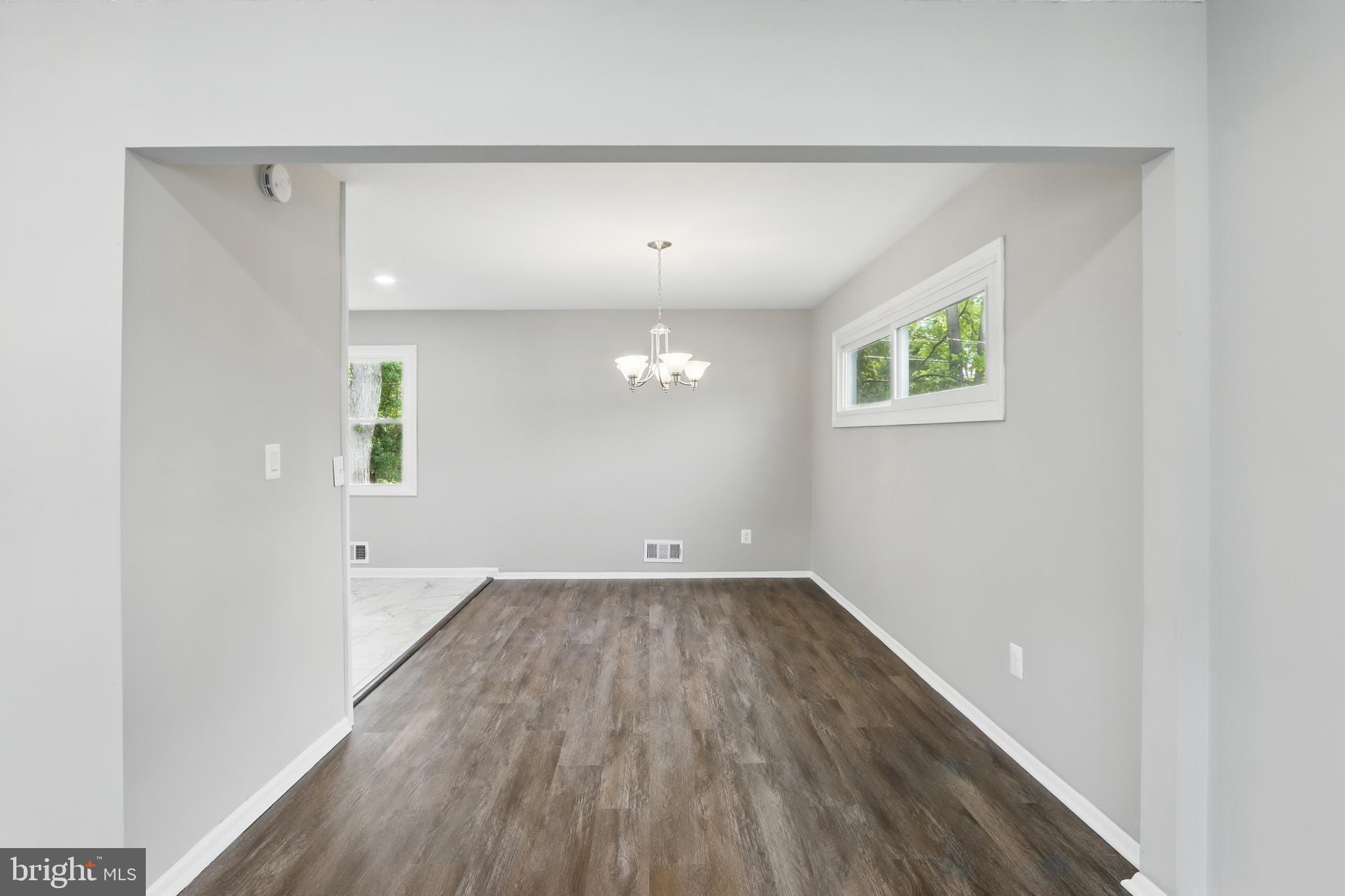 9021 Meadow Heights Road Randallstown, MD 21133 - Photo 11 of 41 an empty room with wooden floor and windows