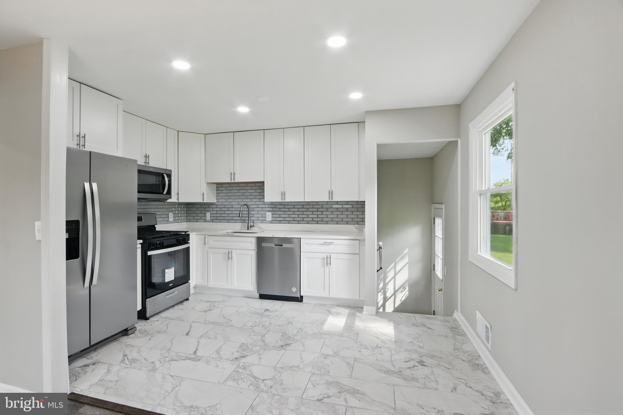 9021 Meadow Heights Road Randallstown, MD 21133 - Photo 14 of 41 a kitchen with a refrigerator sink and microwave