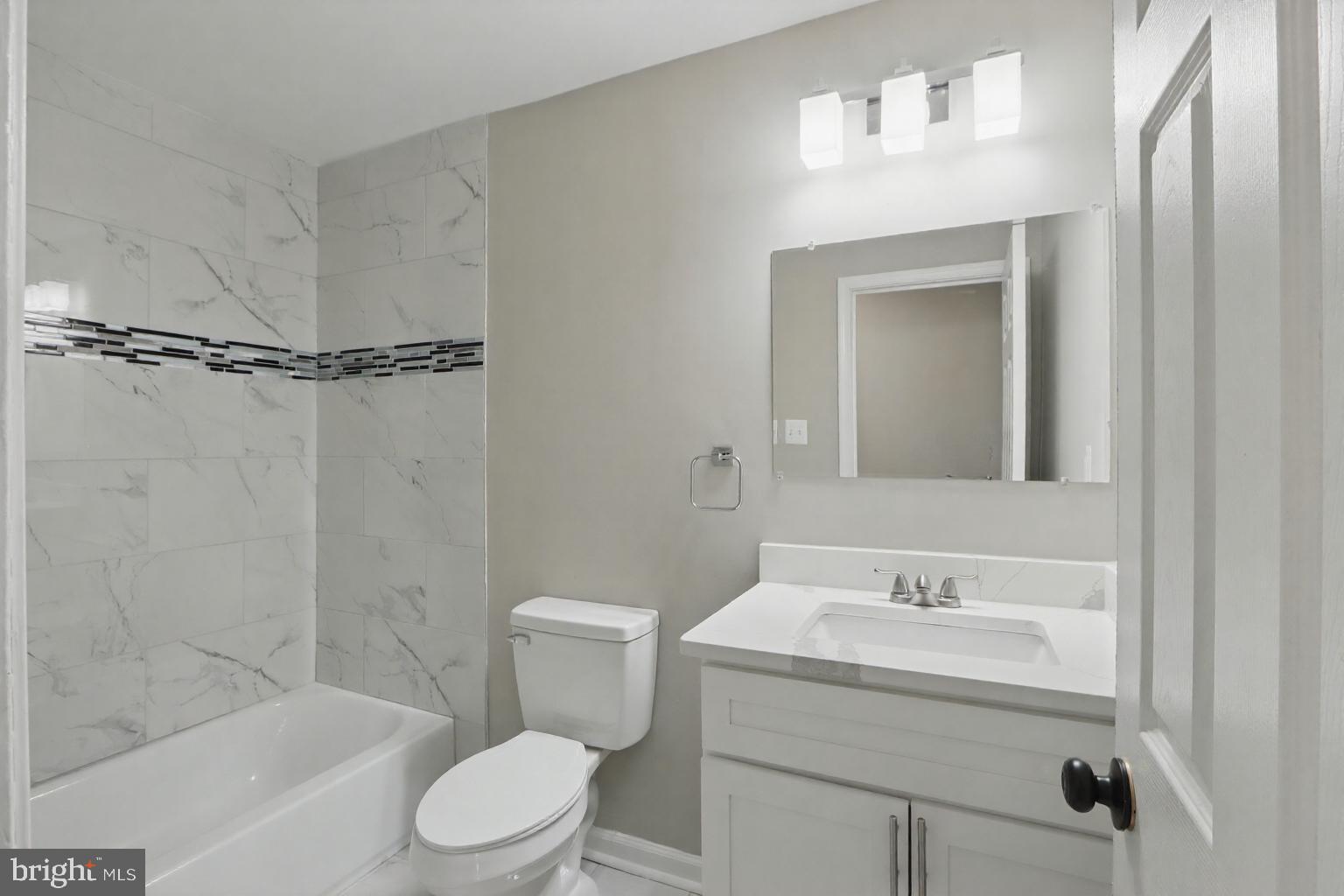 9021 Meadow Heights Road Randallstown, MD 21133 - Photo 18 of 41 a bathroom with a sink toilet and shower