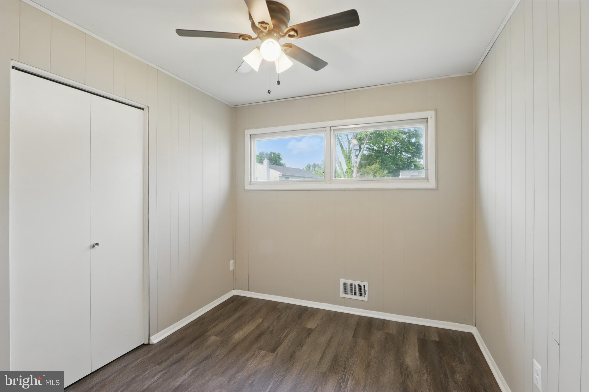9021 Meadow Heights Road Randallstown, MD 21133 - Photo 20 of 41 an empty room with a window and a fan