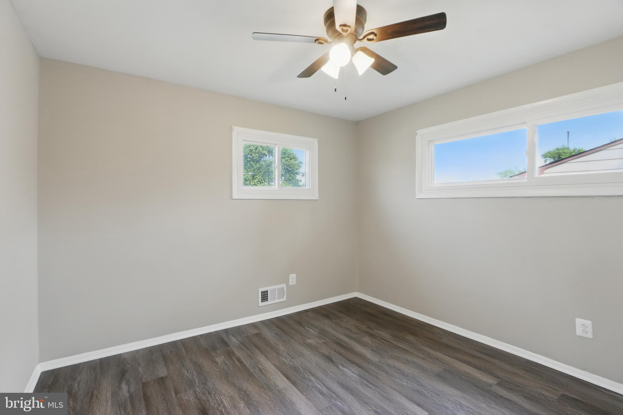 9021 Meadow Heights Road Randallstown, MD 21133 - Photo 21 of 41 an empty room with a window and a fan