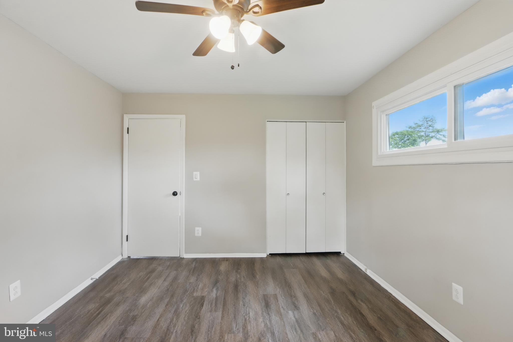 9021 Meadow Heights Road Randallstown, MD 21133 - Photo 23 of 41 wooden floor in an empty room with a window