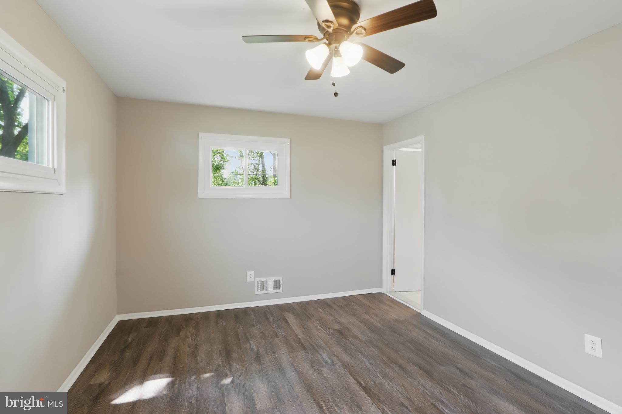 9021 Meadow Heights Road Randallstown, MD 21133 - Photo 25 of 41 wooden floor in an empty room with a window