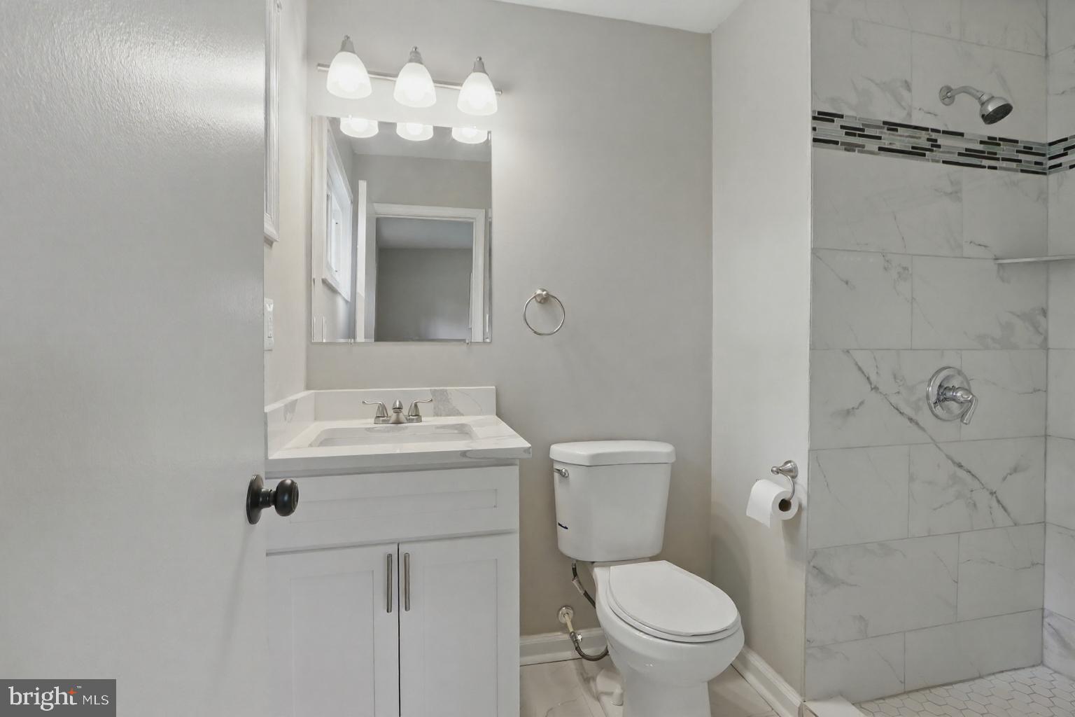 9021 Meadow Heights Road Randallstown, MD 21133 - Photo 32 of 41 a bathroom with a sink a toilet and a mirror