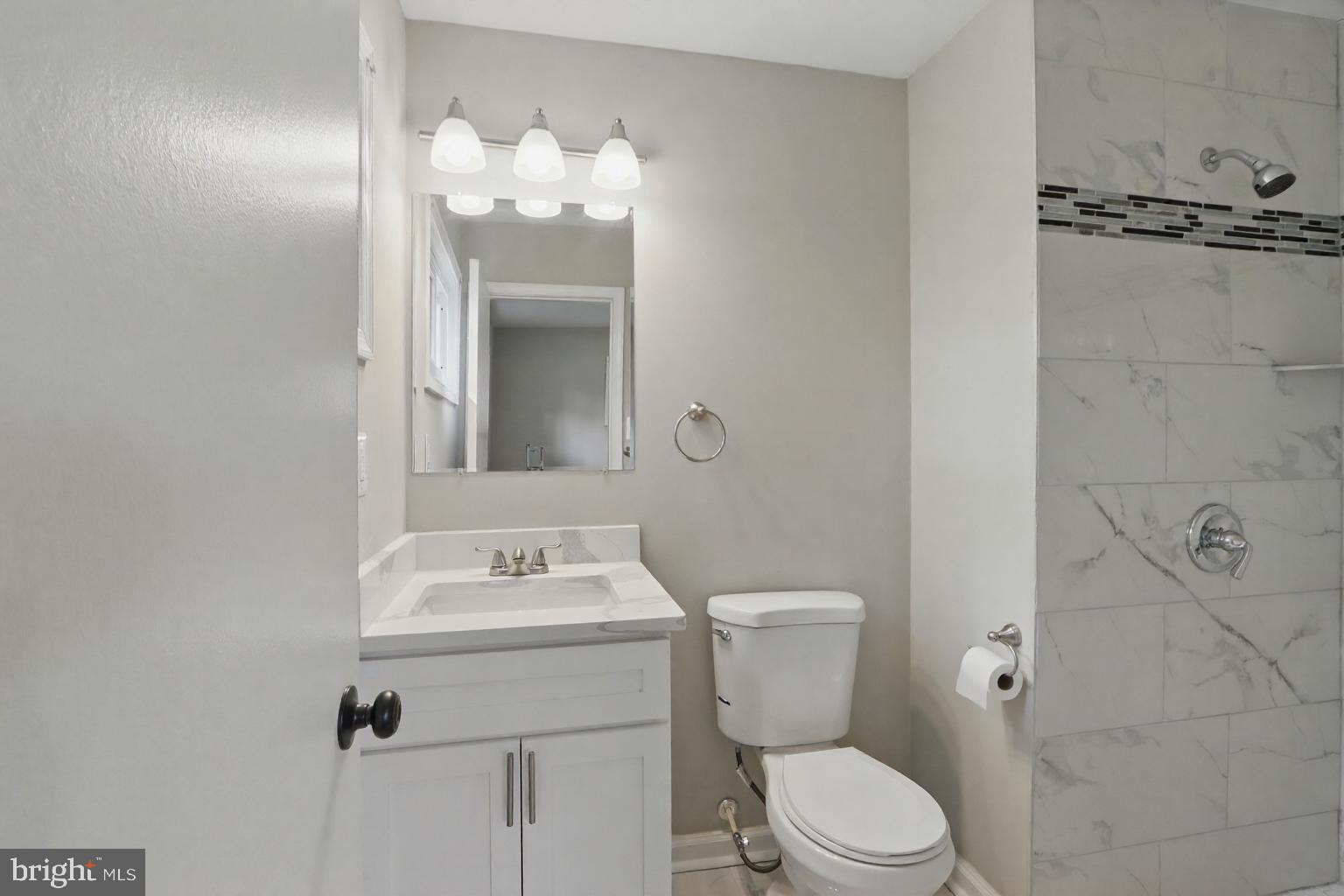 9021 Meadow Heights Road Randallstown, MD 21133 - Photo 33 of 41 a bathroom with a sink vanity mirror and toilet