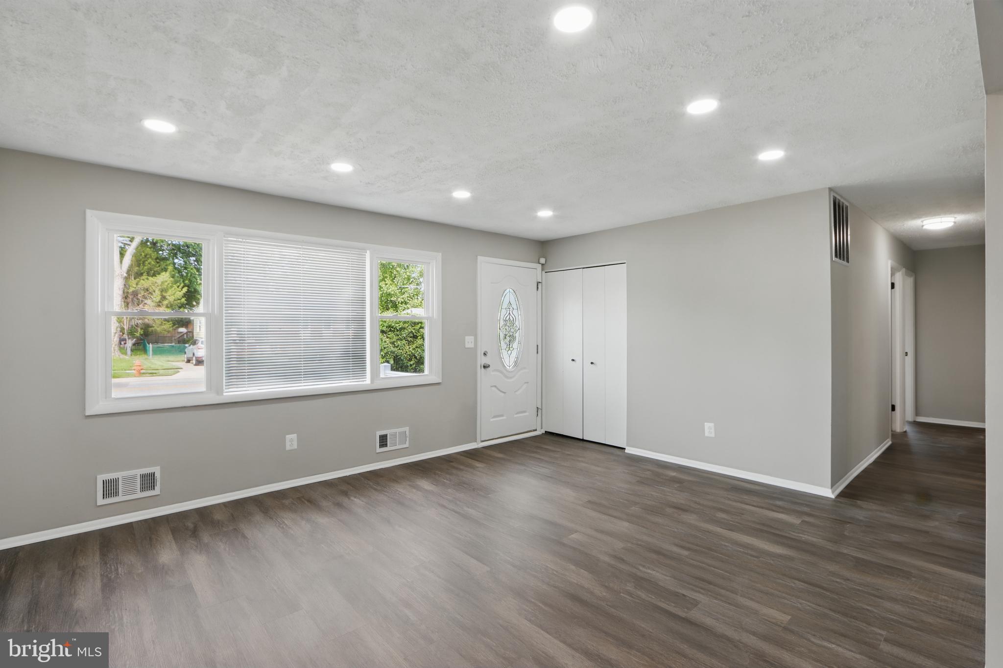 9021 Meadow Heights Road Randallstown, MD 21133 - Photo 4 of 41 an empty room with wooden floor and windows