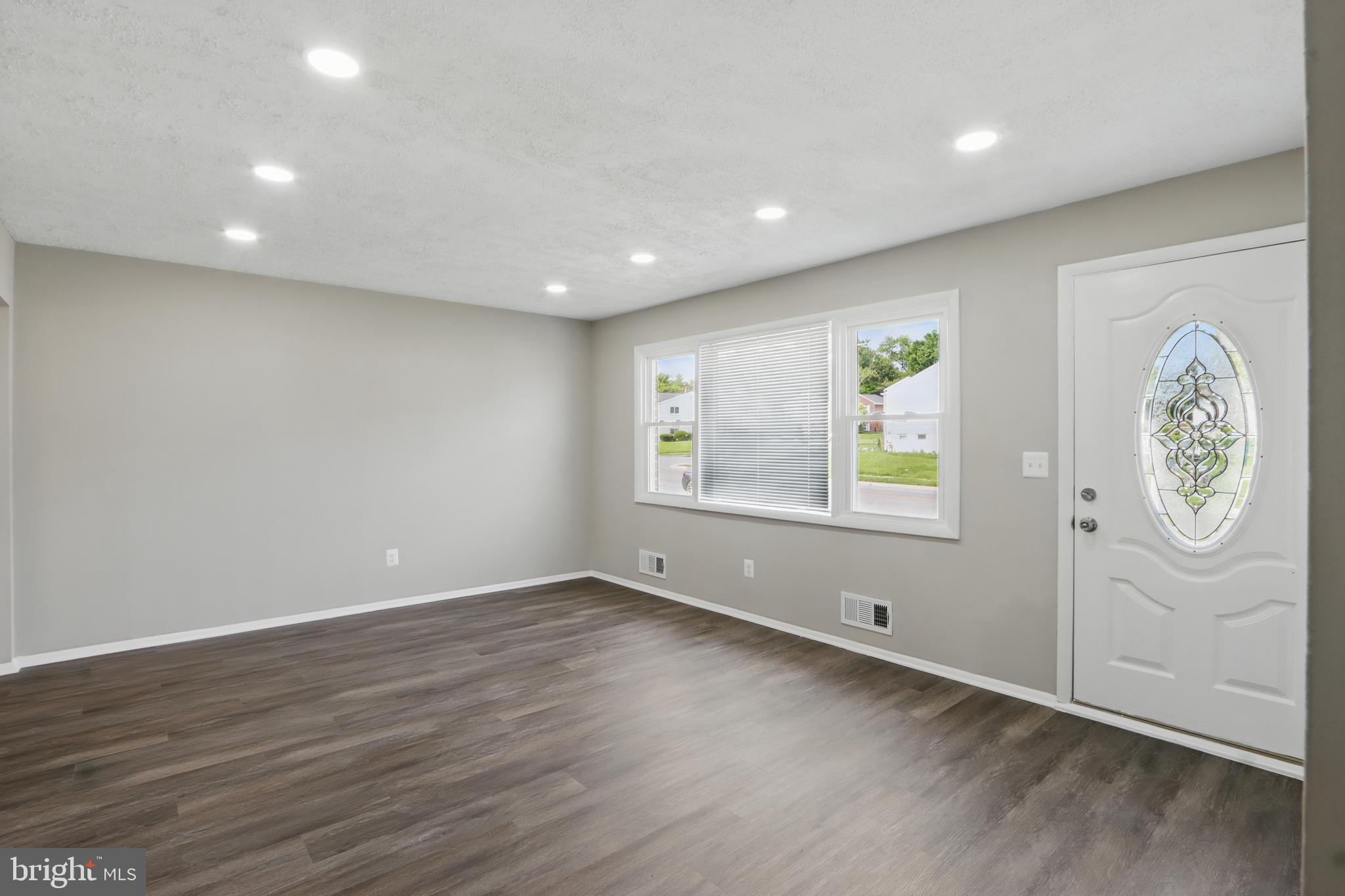 9021 Meadow Heights Road Randallstown, MD 21133 - Photo 5 of 41 an empty room with window and mirror