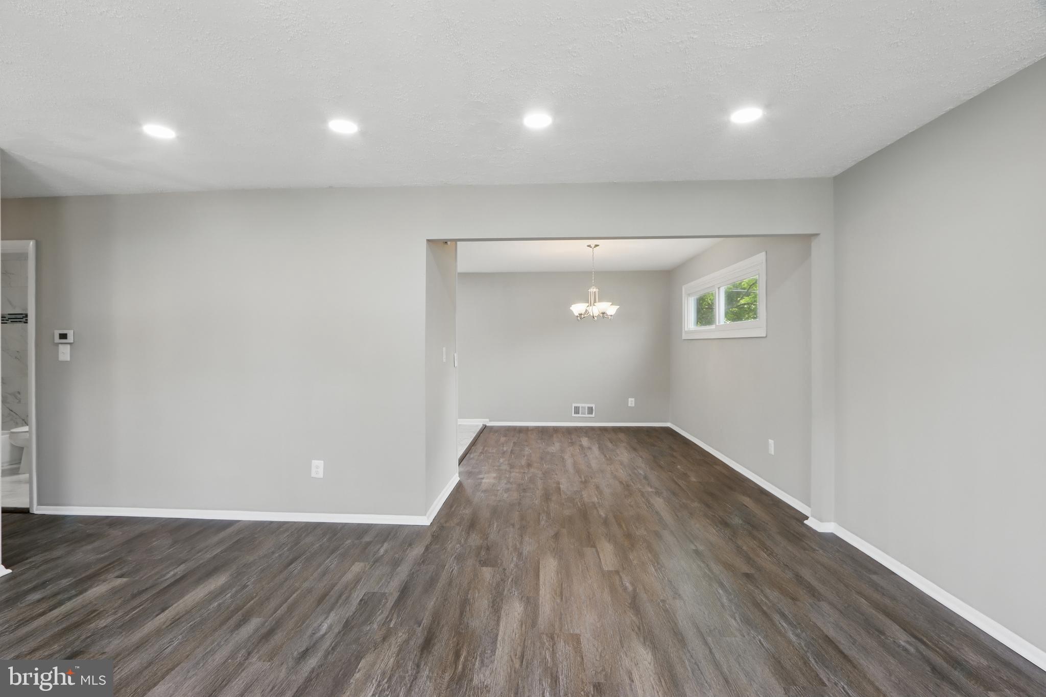 9021 Meadow Heights Road Randallstown, MD 21133 - Photo 10 of 41 an empty room with wooden floor and windows