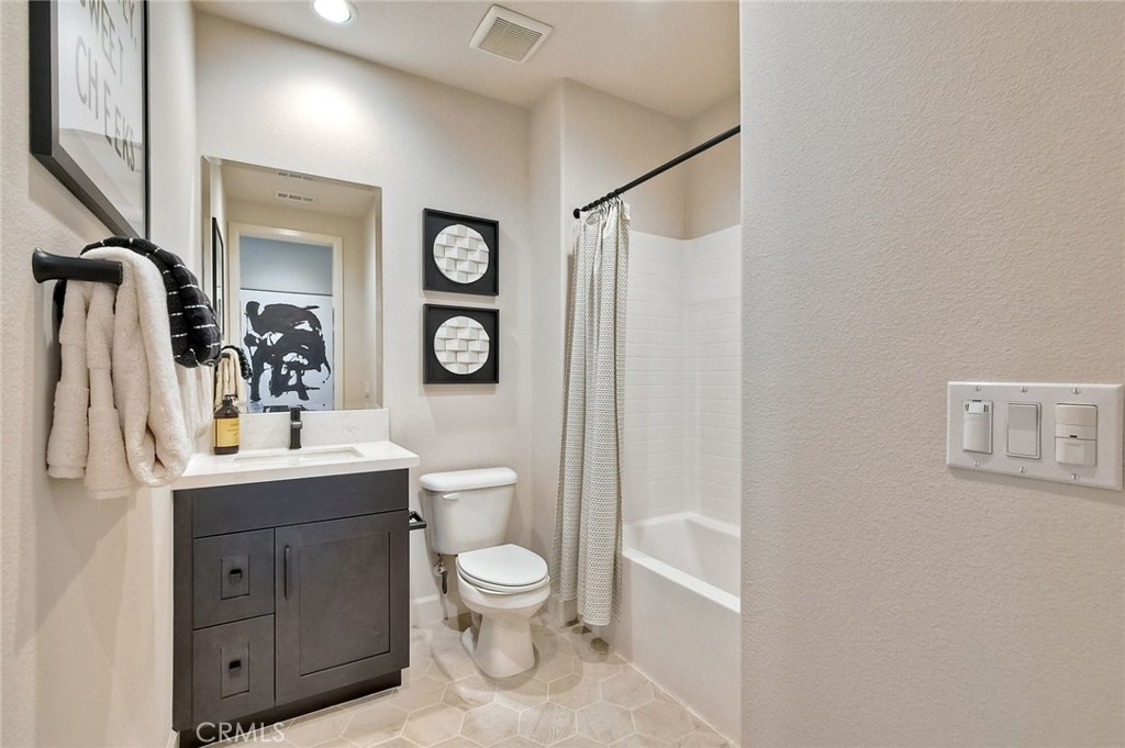 3131 Orchard Glen Escondido, CA 92026 - Photo 16 of 35 a bathroom with a toilet a sink and mirror