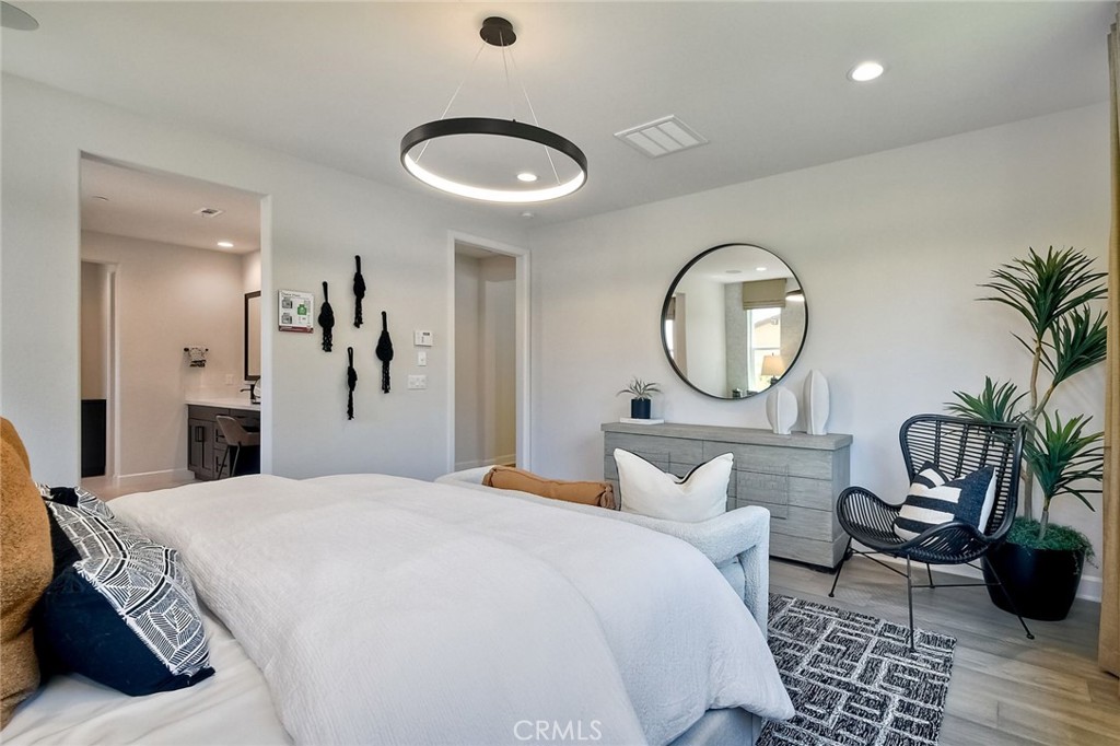 3131 Orchard Glen Escondido, CA 92026 - Photo 22 of 35 a bedroom with a large bed and a chandelier