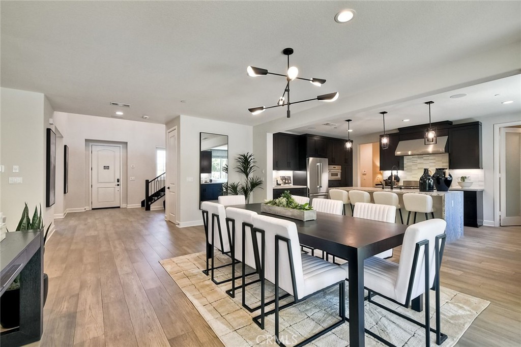 3131 Orchard Glen Escondido, CA 92026 - Photo 6 of 35 a view of a dining room and livingroom with furniture wooden floor a chandelier