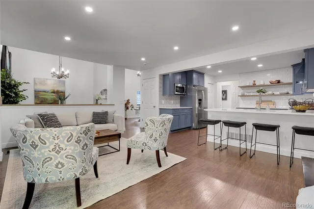a living room with furniture and kitchen view