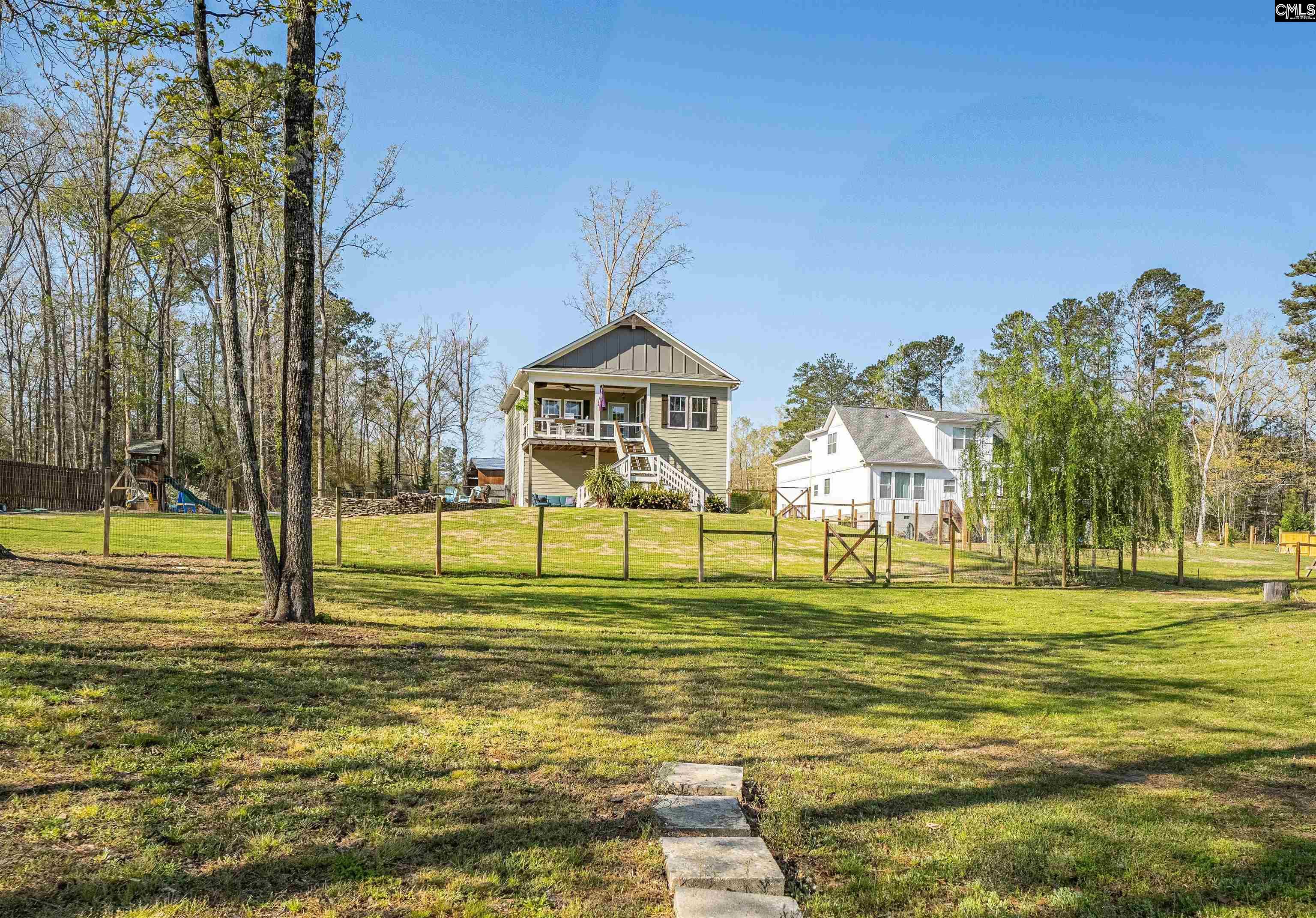 649 Sandbar Road Chapin, SC 29036 - Photo 33 of 40 a swimming pool with outdoor seating and yard