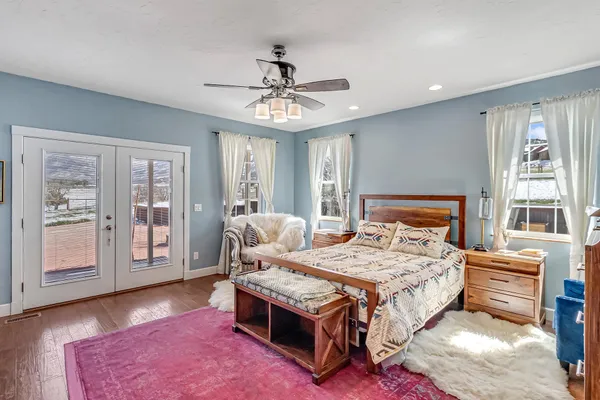 a bedroom with a bed mirror and window