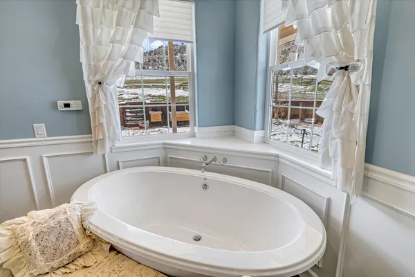 a white bath tub sitting next to a window