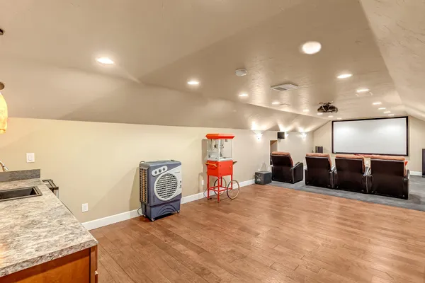 a media room with lots of chairs and a projector screen