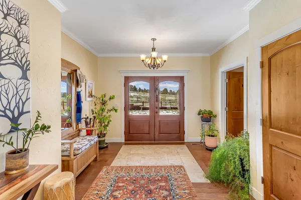 a very nice looking room with a large window and chandelier