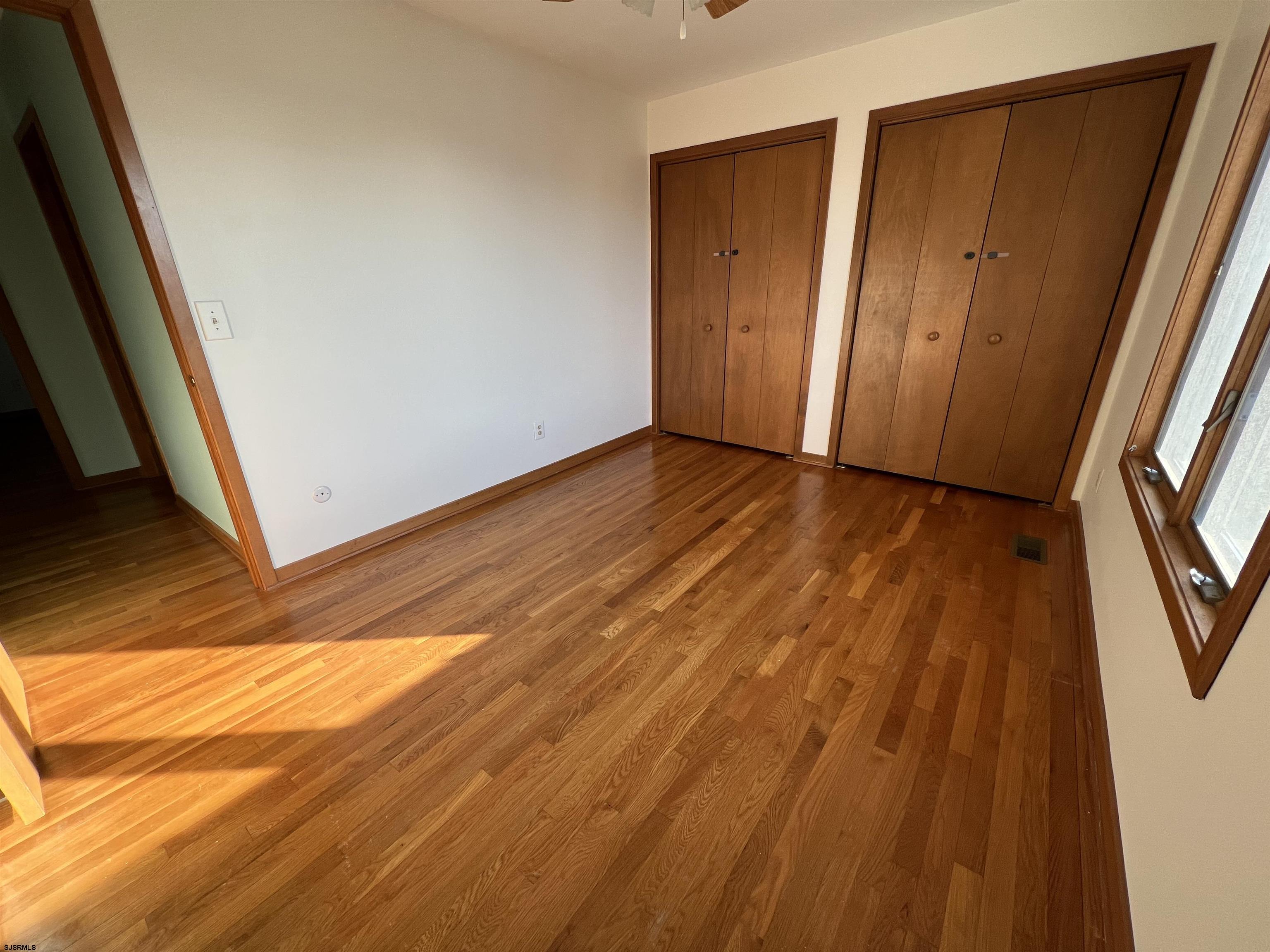 215 Hagen Road Brigantine, NJ 08203 - Photo 13 of 21 a view of an empty room with wooden floor and a window