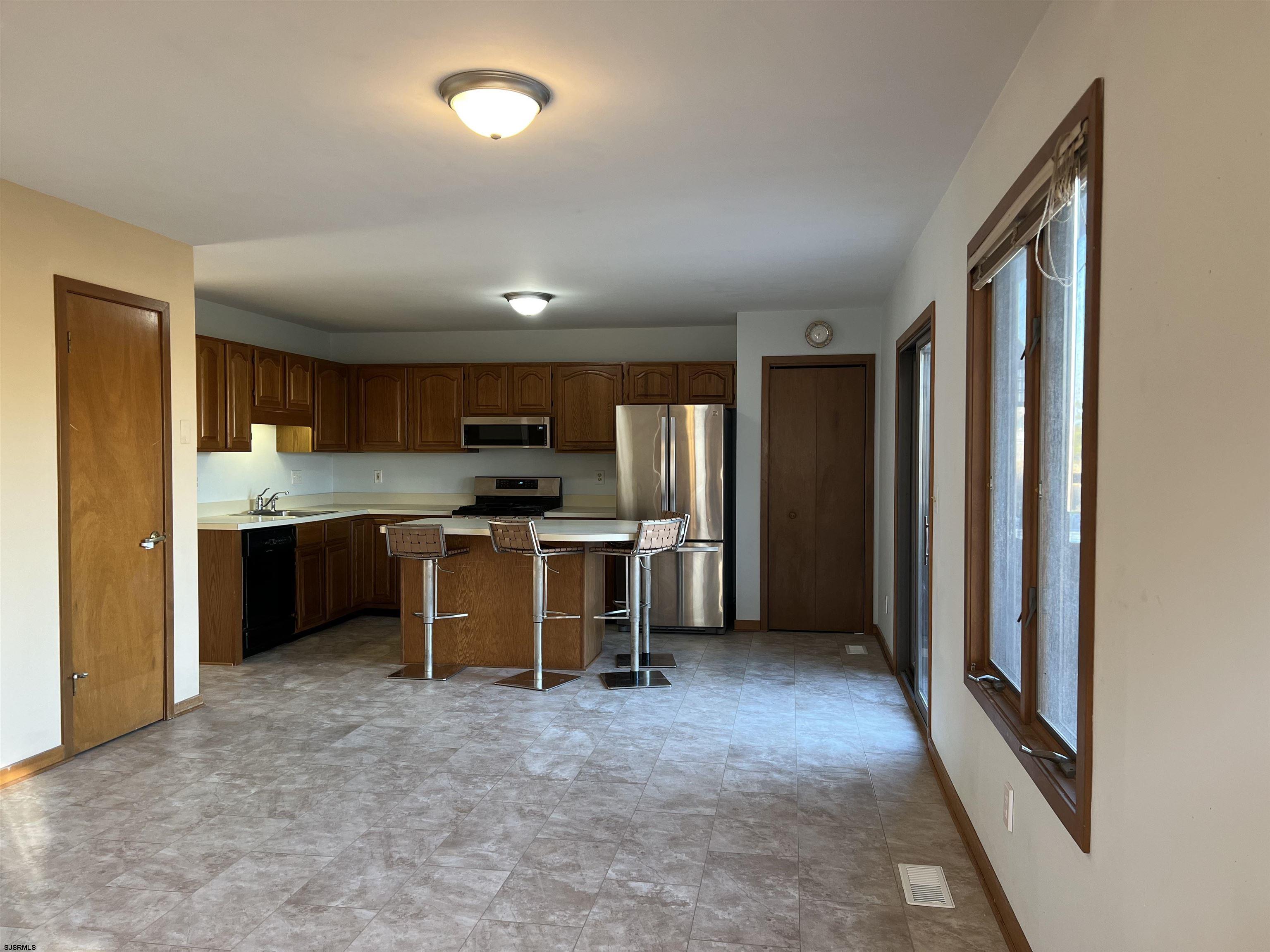 215 Hagen Road Brigantine, NJ 08203 - Photo 3 of 21 a kitchen with stainless steel appliances granite countertop a refrigerator and a stove