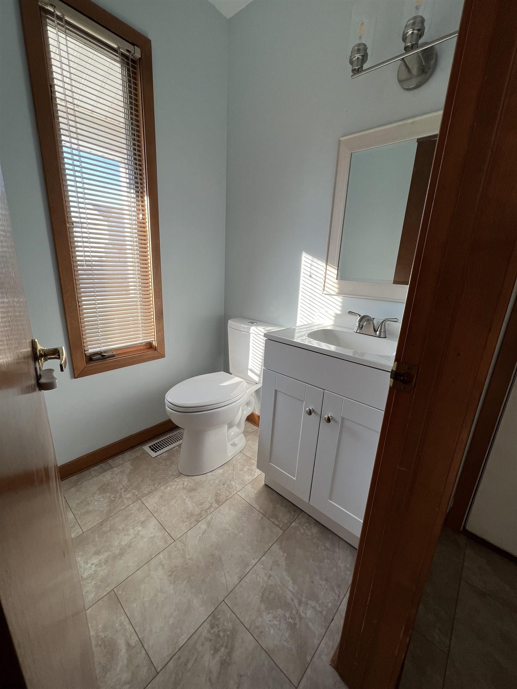 215 Hagen Road Brigantine, NJ 08203 - Photo 8 of 21 a bathroom with a sink toilet and window