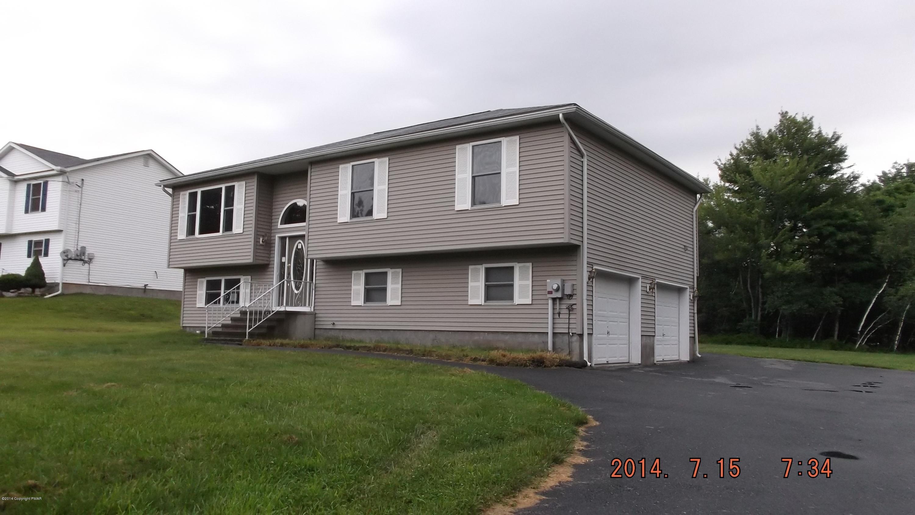 1560 Clover Road Long Pond, PA 18334 - Photo 1 of 18 a front view of a house with a garden