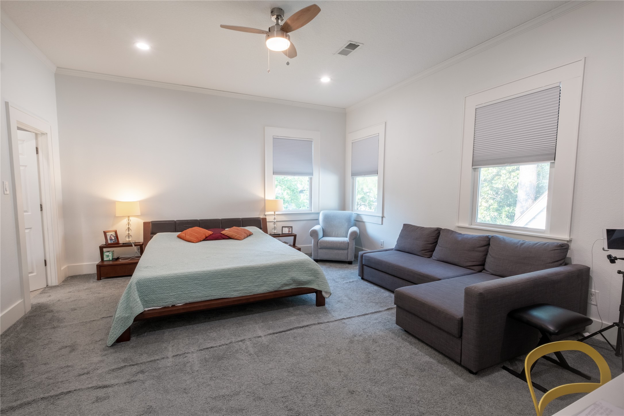 927 Highland Street Houston, TX 77009 - Photo 15 of 24 The primary suite sits upstairs at the front of the home with ample natural light, additional seating space, two closets, and private bathroom.