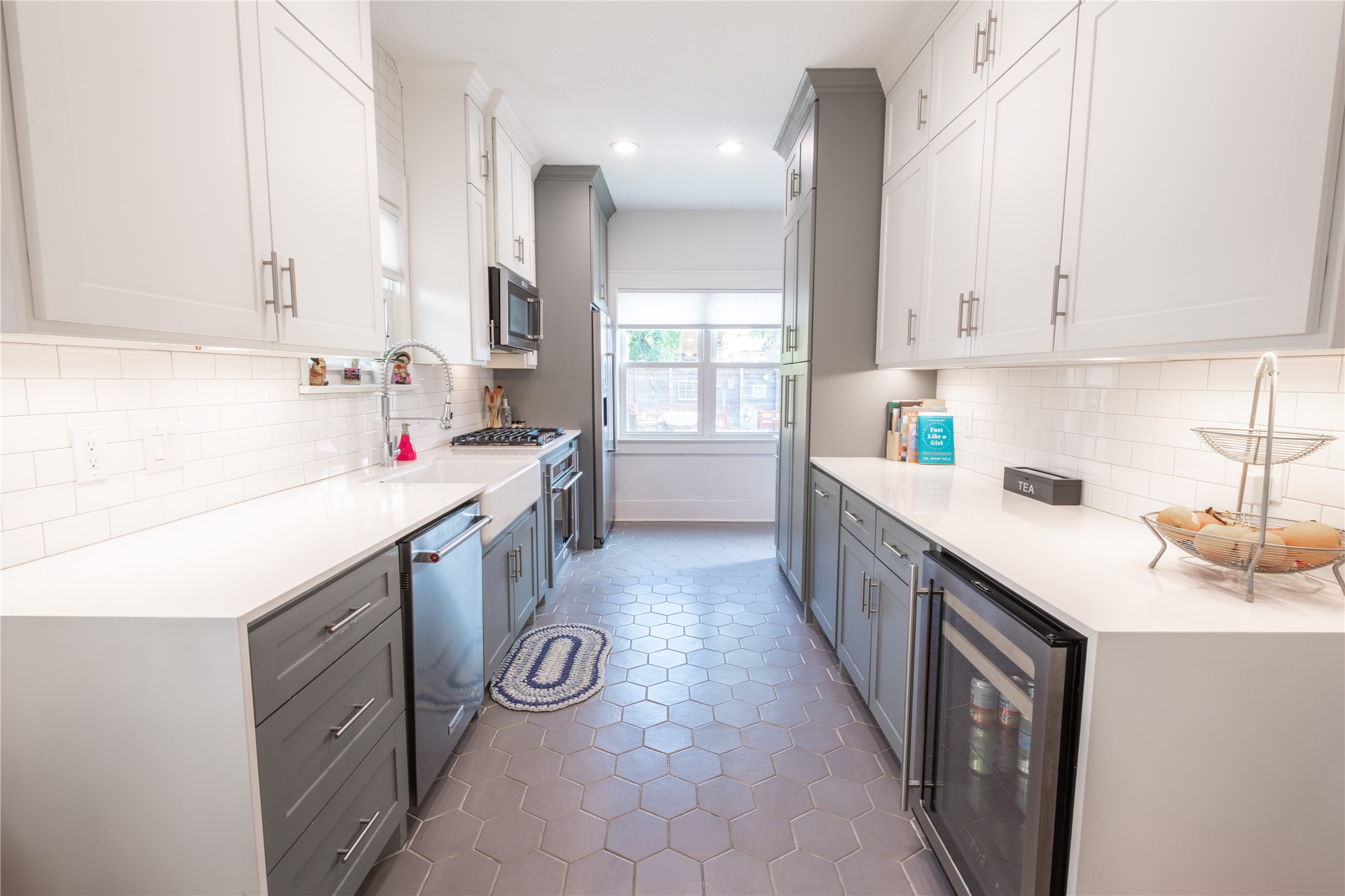 927 Highland Street Houston, TX 77009 - Photo 9 of 24 The renovated galley kitchen offers efficient prep and cooking space and visibility and access to the other living areas.