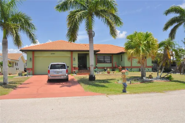 a front view of a house with garden and outdoor seating