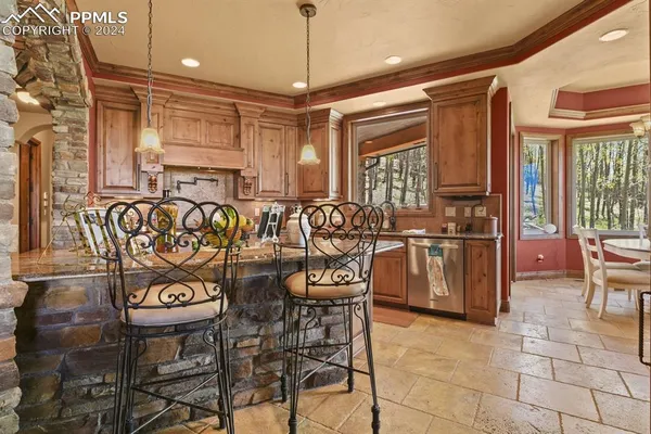 a dining room with furniture a chandelier and wooden floor