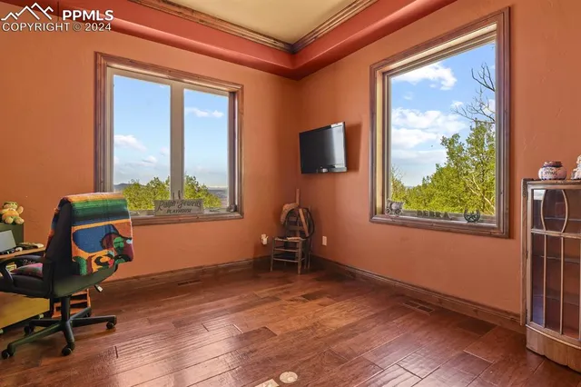 a utility room with granite countertop a sink cabinets and a window
