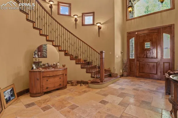 a view of a hallway with entryway and front door