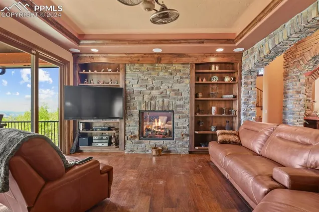 a living room with fireplace furniture and a flat screen tv