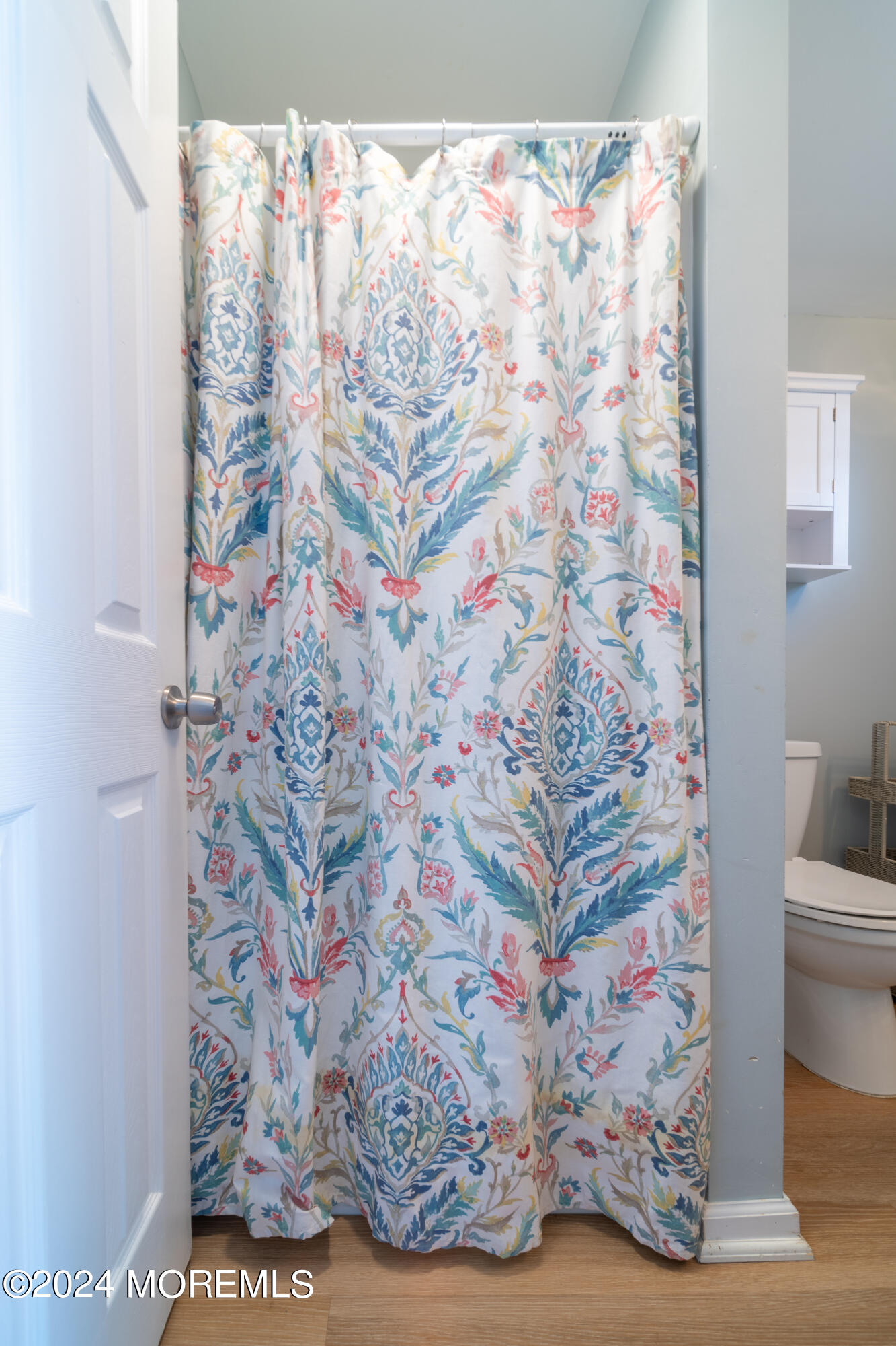 19 Via Ripa Way Sea Bright, NJ 07760 - Photo 20 of 37 a bathroom with a toilet and a shower curtain