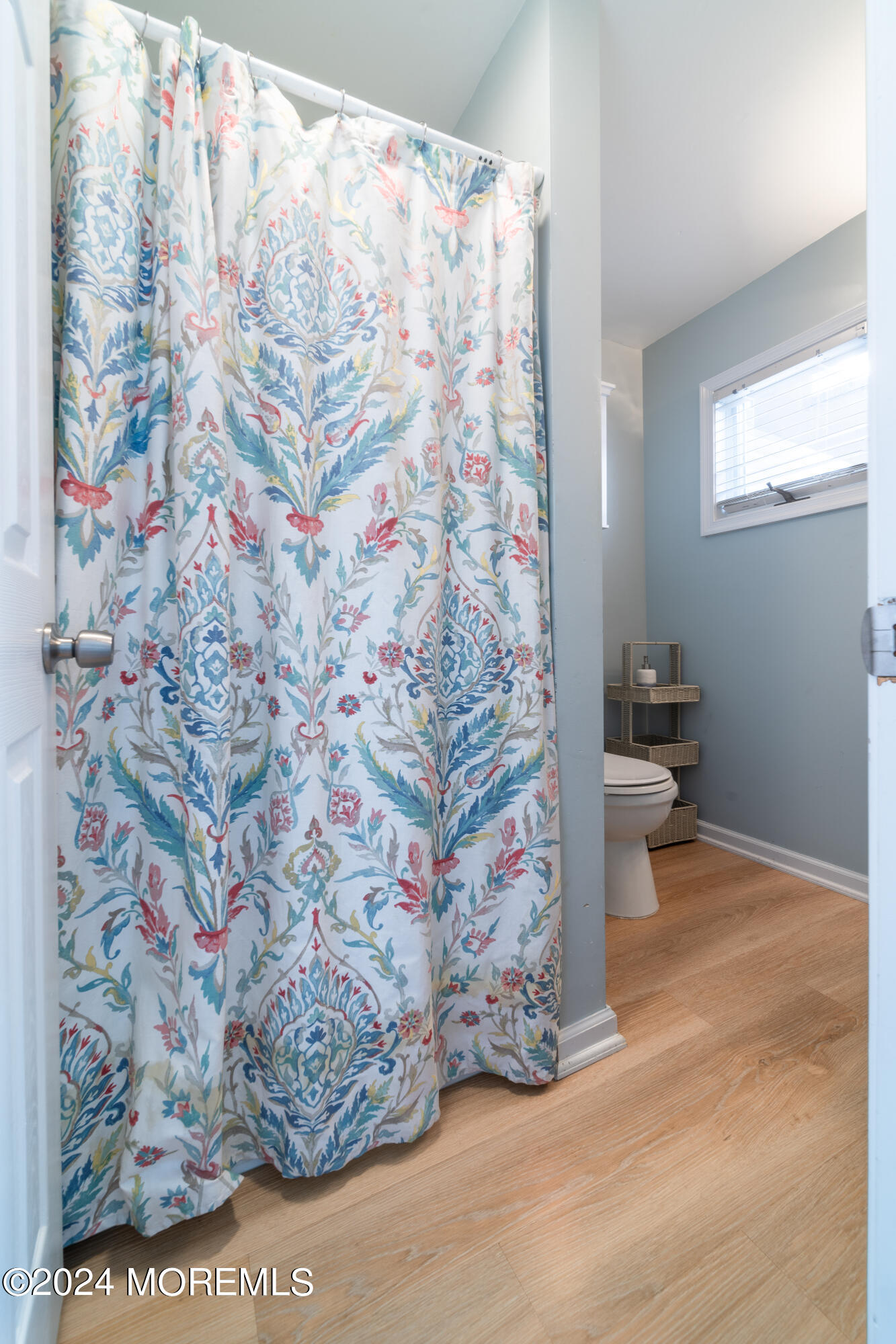 19 Via Ripa Way Sea Bright, NJ 07760 - Photo 21 of 37 a bathroom with a toilet and a shower curtain