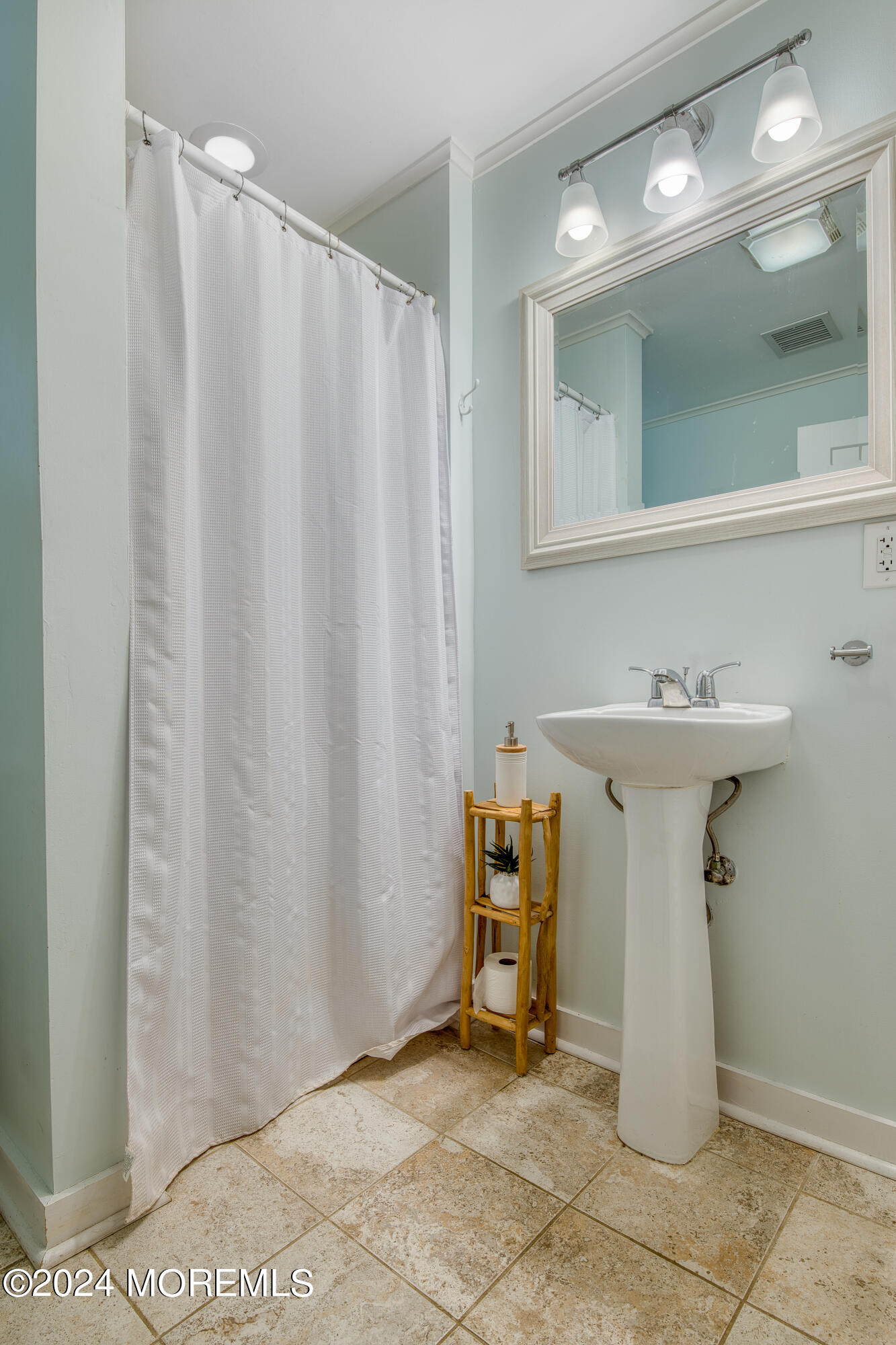19 Via Ripa Way Sea Bright, NJ 07760 - Photo 23 of 37 a bathroom with a sink a mirror and a shower