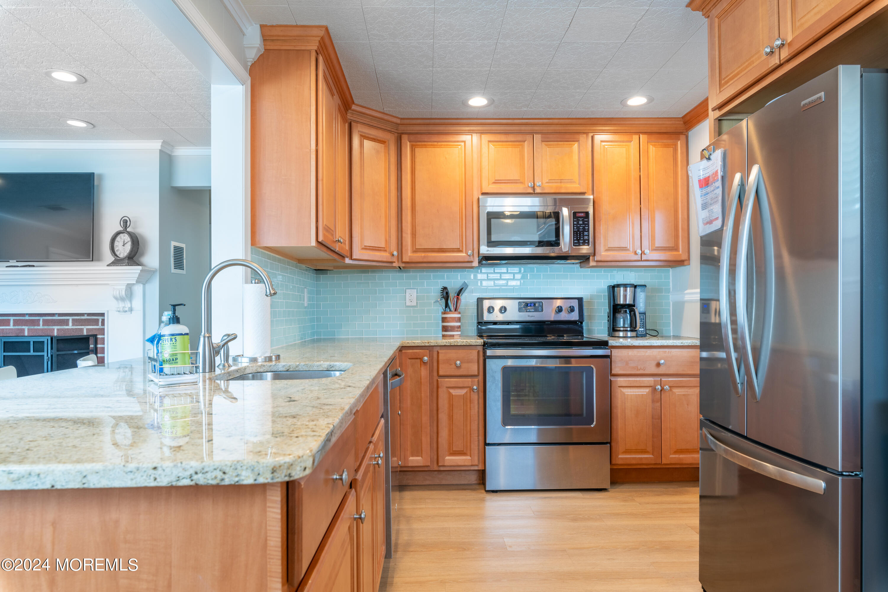 19 Via Ripa Way Sea Bright, NJ 07760 - Photo 7 of 37 a kitchen with stainless steel appliances granite countertop a refrigerator a stove a sink and a microwave