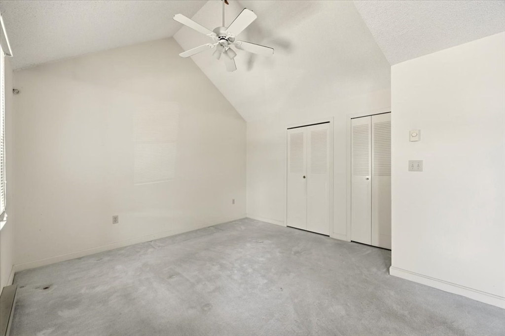 87 Victoria Heights Road, Unit 87 Boston, MA 02136 - Photo 8 of 32 an empty room with a ceiling fan and a window