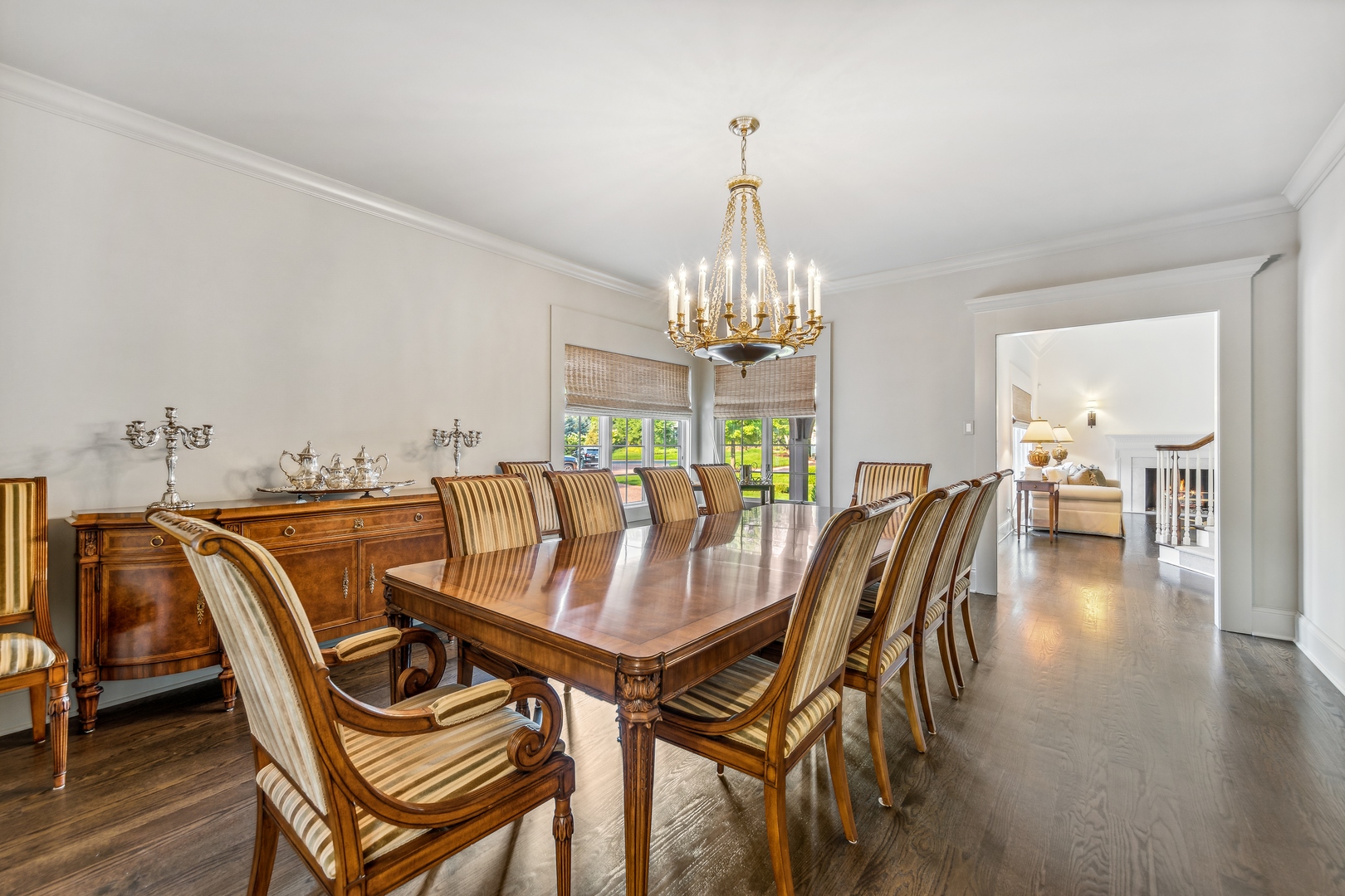 202 Burr Ridge Club Burr Ridge, IL 60527 - Photo 7 of 31 a dining room with furniture a chandelier and wooden floor