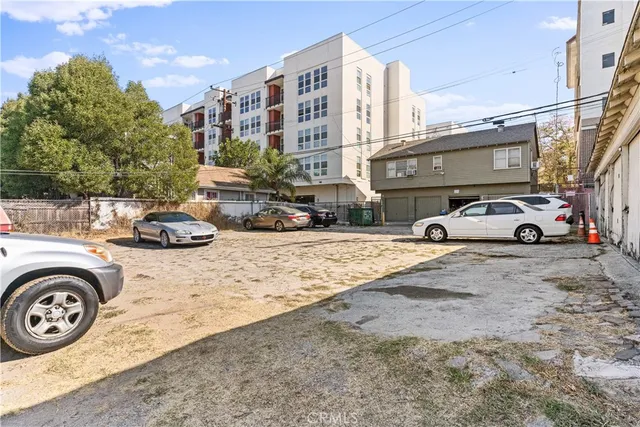 a couple of cars parked in front of a building
