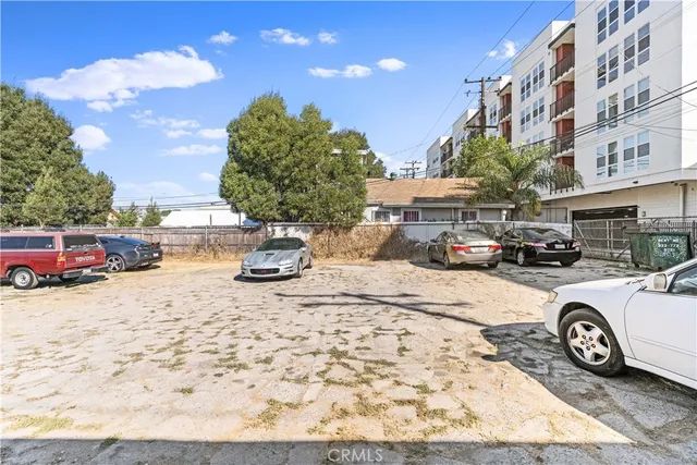 a front view of a house with cars parked