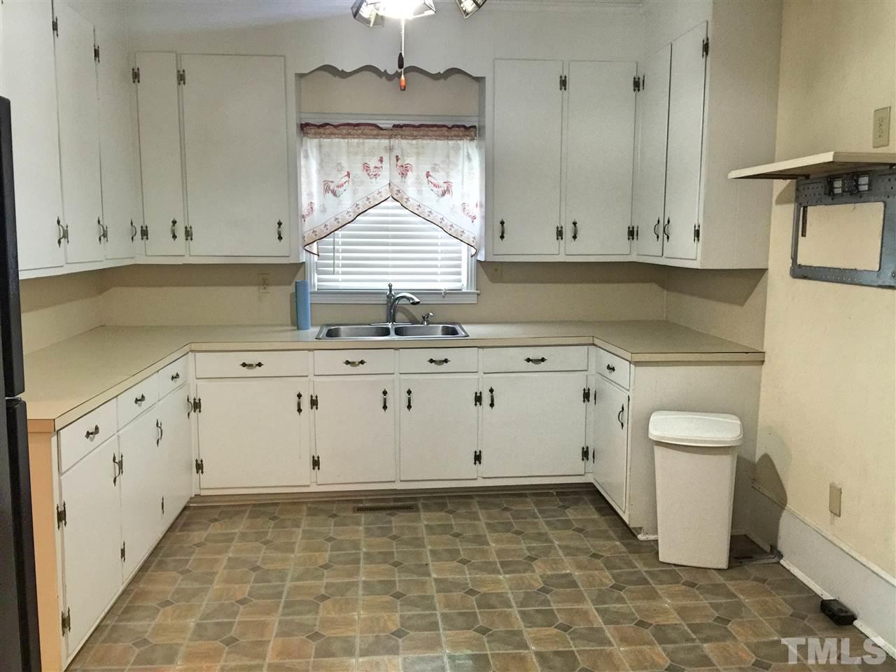 1441 Beacon Street Roxboro, NC 27573 - Photo 5 of 8 a view of cabinets a sink and a stove in a room