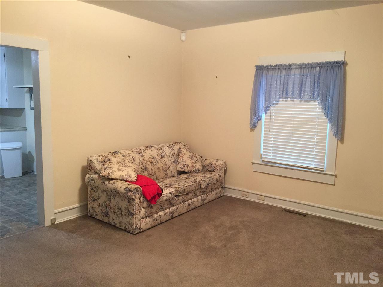 1441 Beacon Street Roxboro, NC 27573 - Photo 6 of 8 a bed sitting in a bedroom next to a window