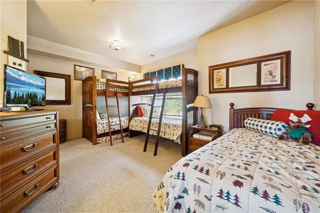 a bedroom with bed and a chandelier