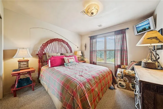 a bedroom with a bed and a table in it