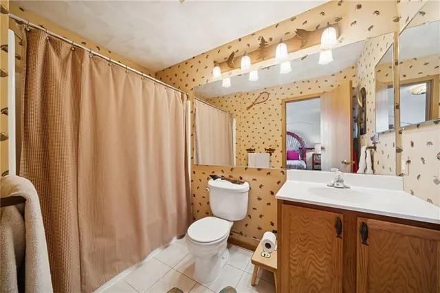 a bathroom with a sink mirror vanity and toilet