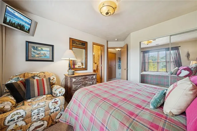 a bedroom with two beds and a two large window