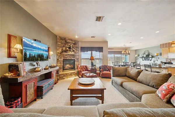 a living room with fireplace furniture and a flat screen tv